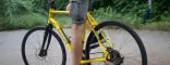 Dettaglio di una trekking bike lite weight tour gialla Boeris Bikes Torino guidata da un ragazzo in un parco cittadino